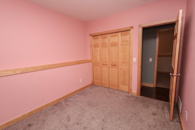 unfurnished bedroom featuring carpet floors and a closet