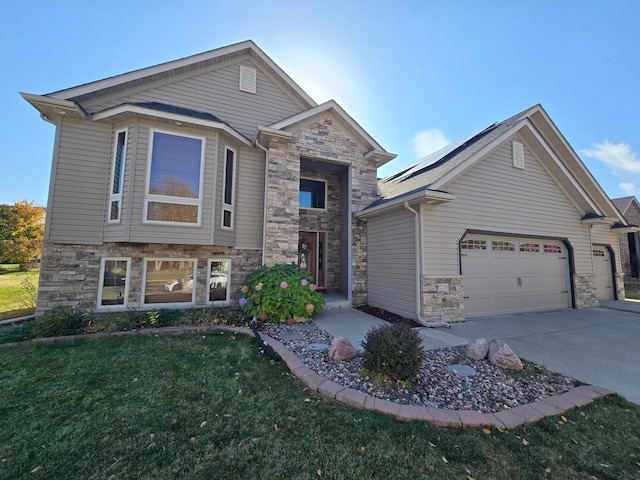 view of front of home with solar panels, a garage, and a front yard