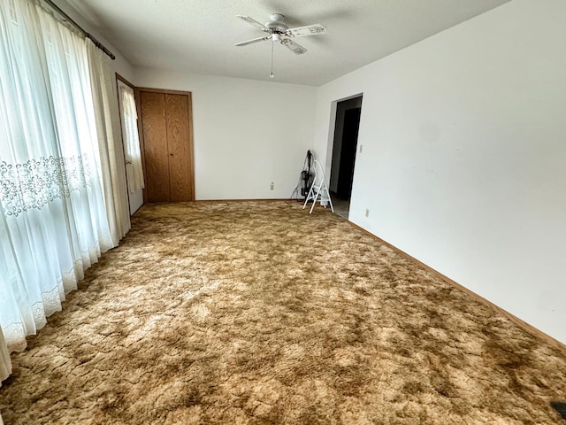 unfurnished bedroom featuring carpet and ceiling fan