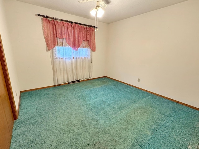 unfurnished room with ceiling fan and carpet floors