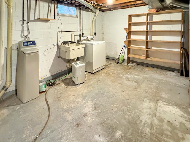 basement featuring washer and clothes dryer and sink