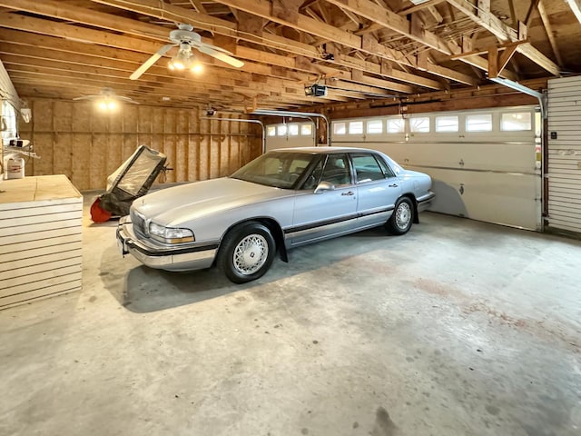 garage with ceiling fan and a garage door opener