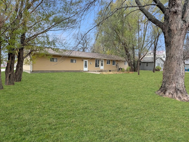 back of house with a lawn