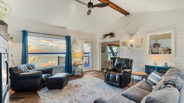 living room with lofted ceiling with beams, ceiling fan, parquet flooring, and wooden walls