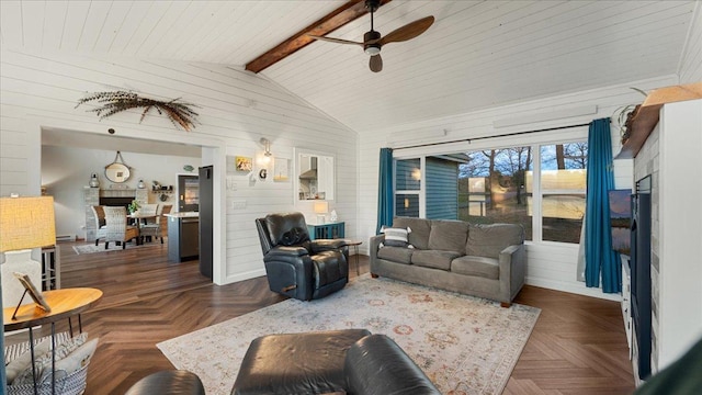 living room with dark parquet flooring, lofted ceiling with beams, ceiling fan, and wood walls