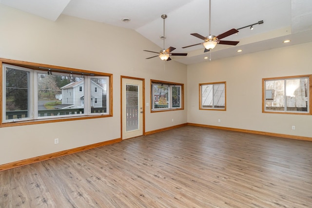 unfurnished living room featuring ceiling fan, lofted ceiling, and light hardwood / wood-style flooring