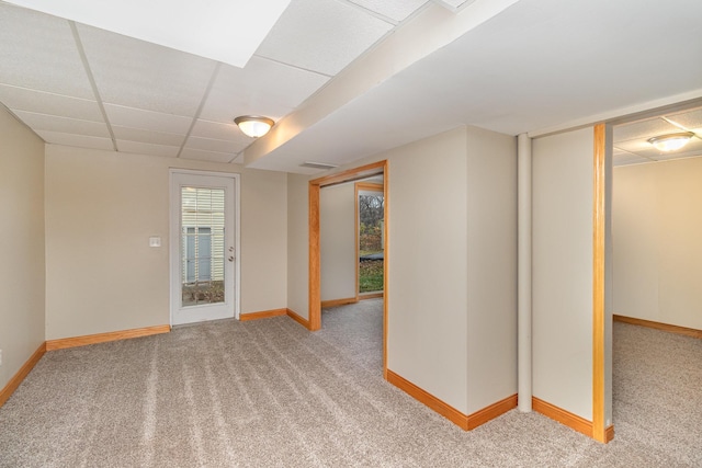 basement featuring carpet floors and a drop ceiling