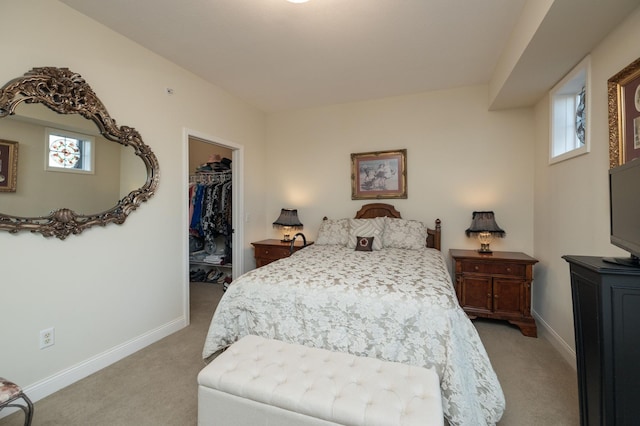 carpeted bedroom with a closet and a spacious closet