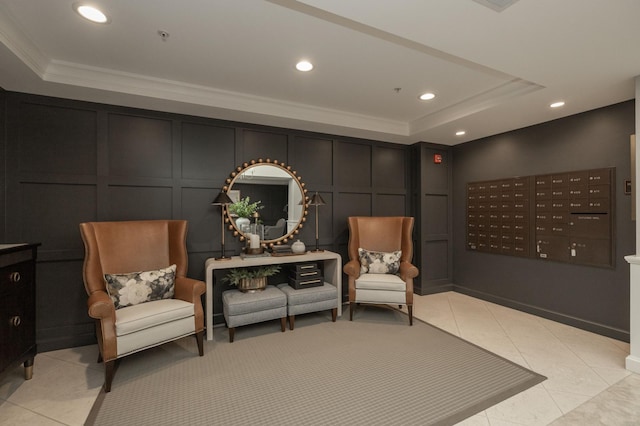 interior space with light tile patterned floors, mail boxes, crown molding, and a raised ceiling