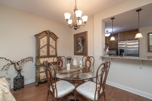 dining area featuring dark hardwood / wood-style floors and a notable chandelier