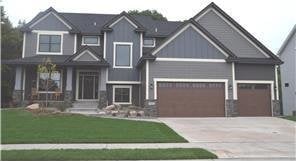 craftsman inspired home featuring a garage and a front yard