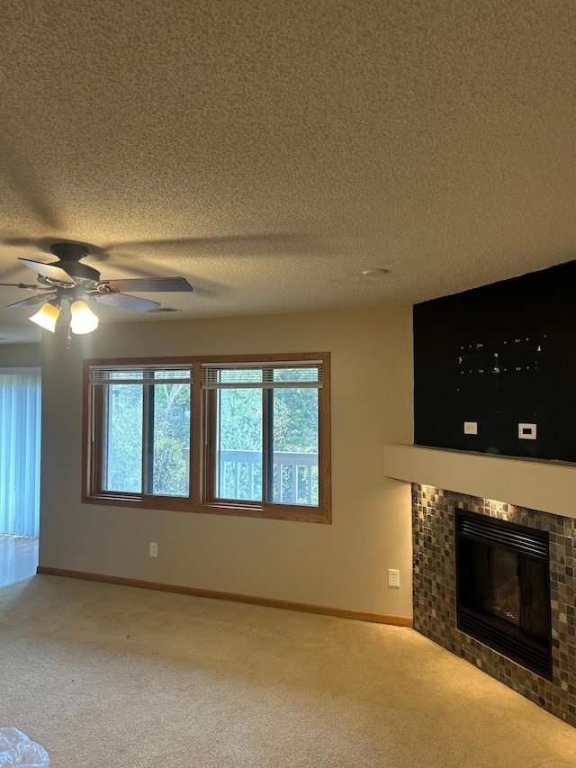 unfurnished living room featuring carpet flooring, a textured ceiling, and a healthy amount of sunlight