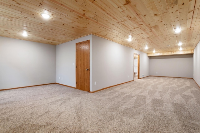 basement featuring wooden ceiling and carpet floors