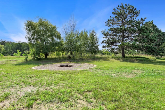 view of yard with an outdoor fire pit