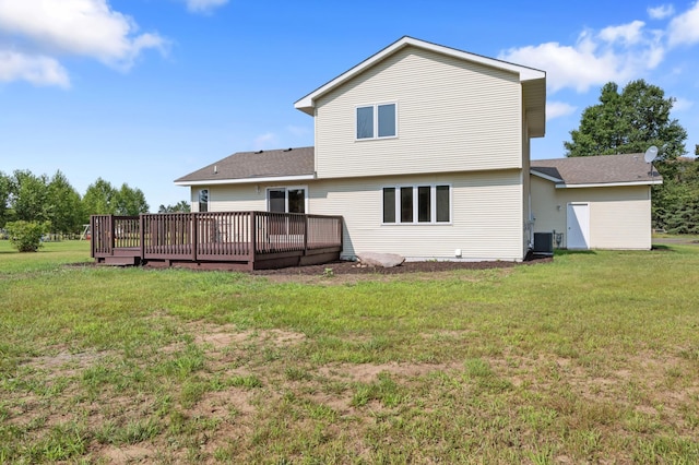 rear view of property with central AC unit, a lawn, and a wooden deck