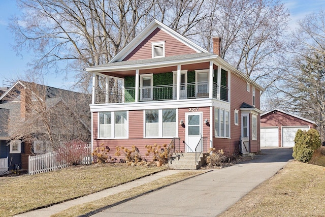 view of front of property with a garage, a front yard, an outdoor structure, and a balcony