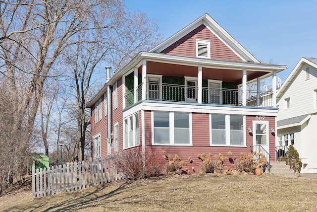 view of front of home featuring a front lawn and a balcony