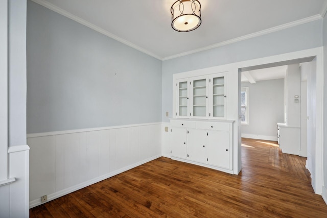 unfurnished room with hardwood / wood-style floors and ornamental molding