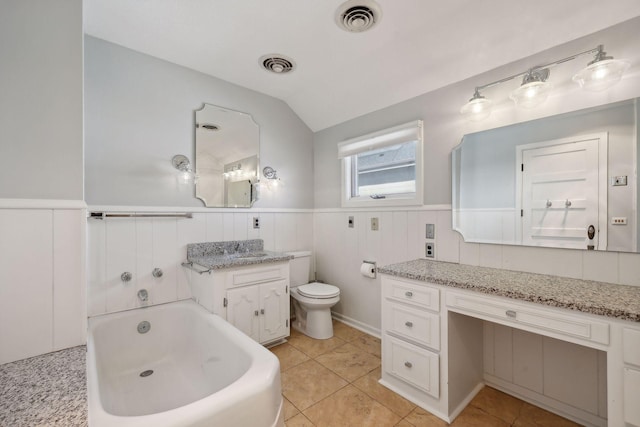 bathroom featuring vanity, tile patterned floors, a bathtub, and vaulted ceiling