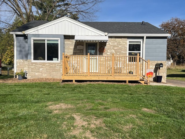 rear view of house featuring a yard and a deck