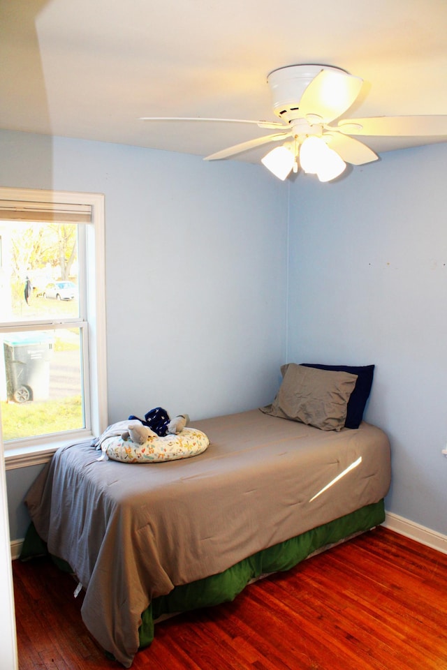 bedroom featuring hardwood / wood-style flooring and ceiling fan