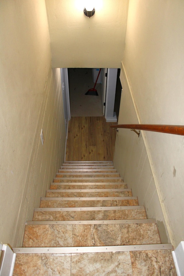 stairway featuring wood-type flooring