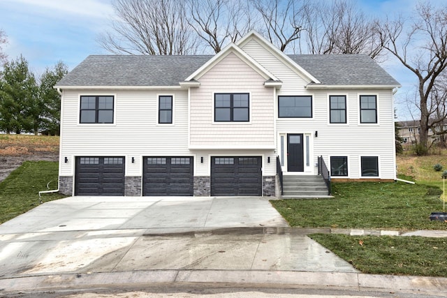 split foyer home with concrete driveway, roof with shingles, a front yard, stone siding, and an attached garage