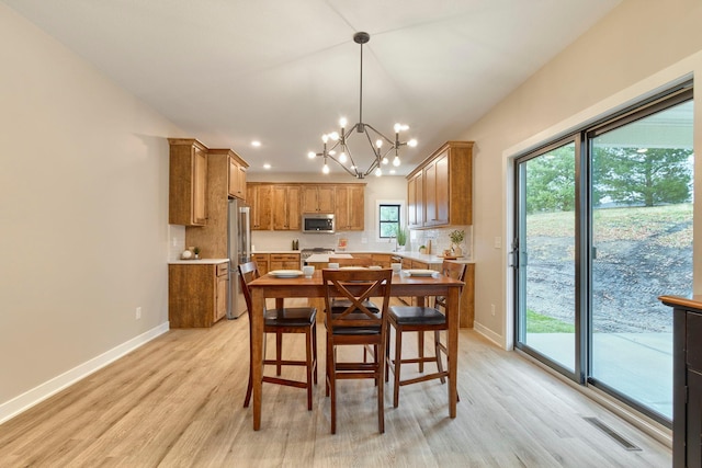 dining room featuring a notable chandelier and light hardwood / wood-style floors