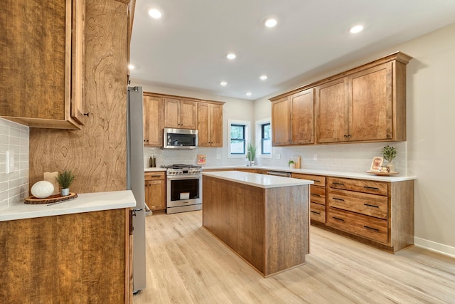 kitchen with light wood-style floors, brown cabinets, backsplash, and stainless steel appliances