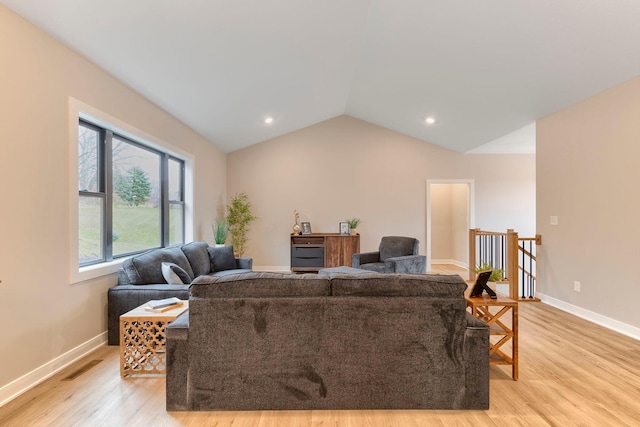 living room with light wood finished floors, visible vents, baseboards, lofted ceiling, and recessed lighting