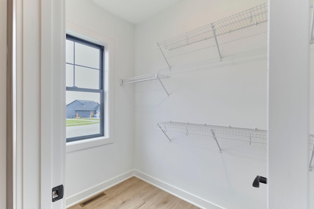 walk in closet with light wood-style floors and visible vents