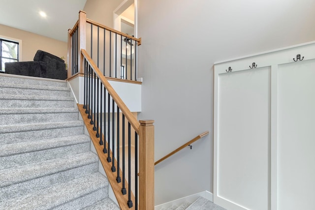 stairway featuring wood finished floors