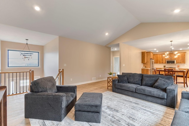 living area featuring baseboards, an inviting chandelier, light wood-style flooring, recessed lighting, and vaulted ceiling