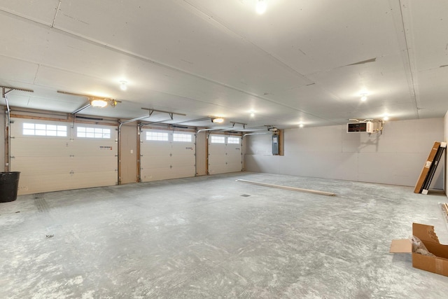 garage with electric panel and a garage door opener