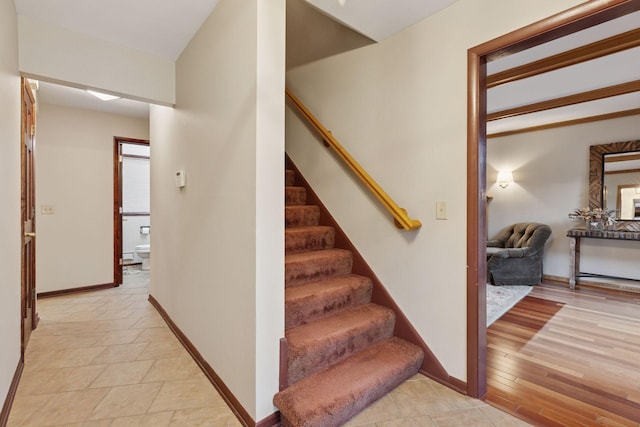 stairs with baseboards and wood finished floors