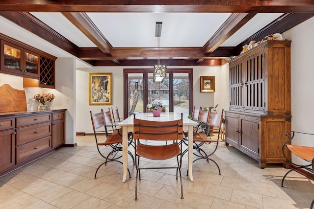 dining area featuring beam ceiling, baseboards, and ornamental molding