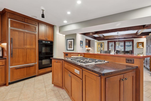 kitchen with brown cabinets, built in fridge, dobule oven black, and stainless steel gas cooktop