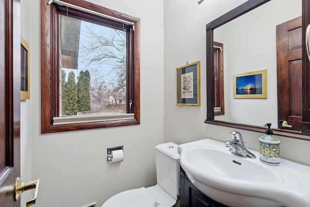 half bath featuring a sink and toilet