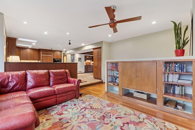 living room featuring recessed lighting, a ceiling fan, and light wood finished floors