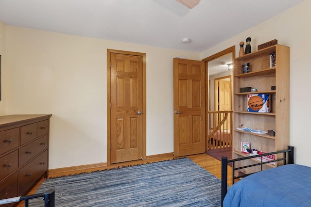 bedroom featuring baseboards and light wood-style floors