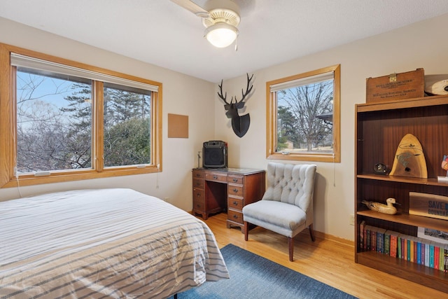 bedroom featuring a ceiling fan and wood finished floors