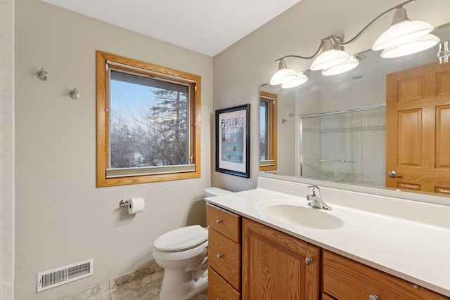 bathroom with a shower with door, visible vents, toilet, and vanity