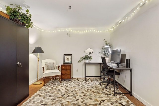 carpeted office space featuring baseboards