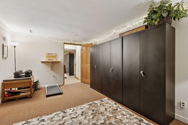 carpeted bedroom featuring baseboards and two closets