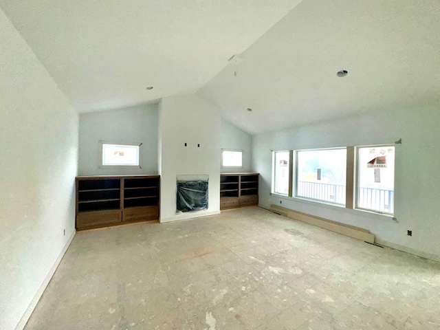 unfurnished living room featuring vaulted ceiling