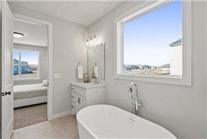 bathroom with a tub to relax in and vanity