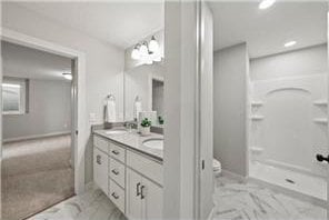 bathroom with vanity, toilet, and a shower