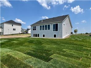 rear view of property with a lawn