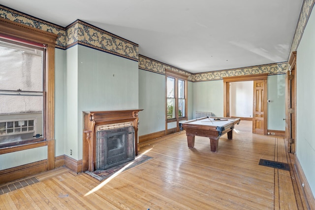 recreation room with radiator heating unit, light hardwood / wood-style floors, and pool table