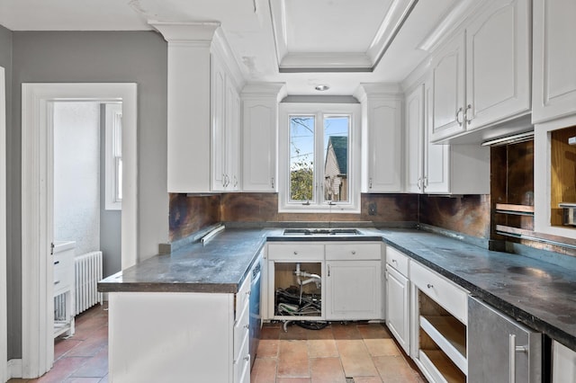 kitchen featuring radiator, tasteful backsplash, a tray ceiling, white cabinetry, and decorative columns